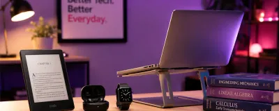 A desk with student gift ideas including an e-reader, earbuds, and a laptop stand