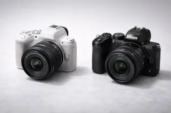 Side-by-side comparison of Canon EOS R100 and Nikon Z50 II cameras