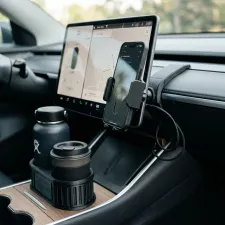 3D printed phone mount and cup holder expander in a modern car interior