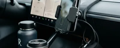 3D printed phone mount and cup holder expander in a modern car interior