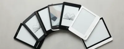Collection of e-readers from Kindle, Kobo, and Boox on a clean surface