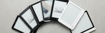 Collection of e-readers from Kindle, Kobo, and Boox on a clean surface