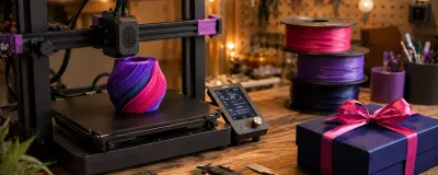 A 3D printer surrounded by filament spools, hand tools, and finished prints as gift ideas