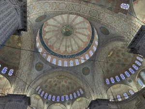 Interior view of the Blue Mosque (Sultan Ahmed Camii) in Istanbul with its iconic blue Iznik tiles and central dome