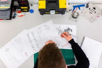 3D printer with cost breakdown elements on a modern desk
