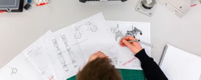 3D printer with cost breakdown elements on a modern desk