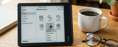 An e-reader device running KOReader displaying the plugins menu next to glasses and a coffee cup on a wooden desk.