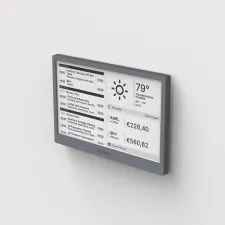 A minimalist workspace featuring a TRMNL E-ink display showing GitHub contributions and weather.