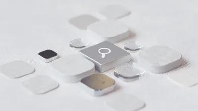 A glowing magnifying glass dissolving into digital data particles, representing the transition from traditional search to AI