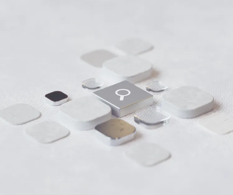 A glowing magnifying glass dissolving into digital data particles, representing the transition from traditional search to AI