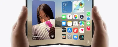 Apple iPhone Duo foldable smartphone in Night Sky finish on a modern desk showing both the folded outer screen and unfolded inner display