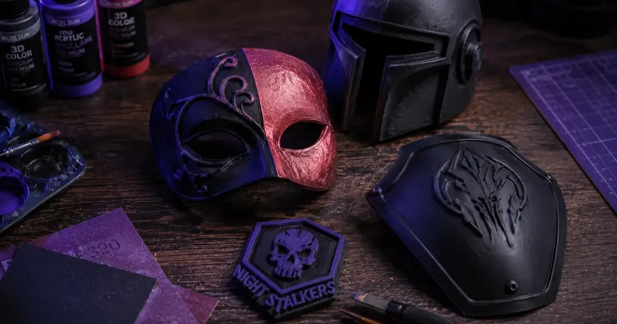 3D printed Halloween costume pieces including a mask and props laid out on a table