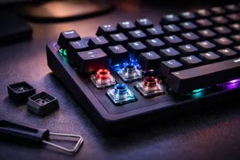 Collection of mechanical keyboards with colorful keycaps on a desk
