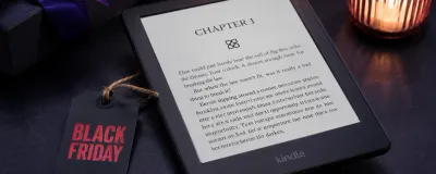 A Kindle with a Black Friday sale tag next to a shopping cart icon