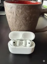 AirPods Pro 3 in their charging case on a modern desk