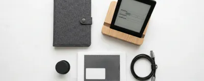 Collection of Kindle accessories including cases, stands, and chargers