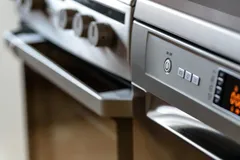 A modern AI-powered smart kitchen with a connected refrigerator and precision oven displaying meal-planning data on glowing screens