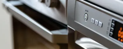 A modern AI-powered smart kitchen with a connected refrigerator and precision oven displaying meal-planning data on glowing screens