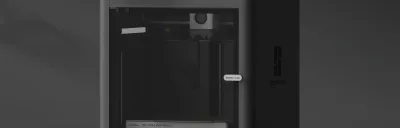 Beginner-friendly 3D printer on a desk with a freshly printed object