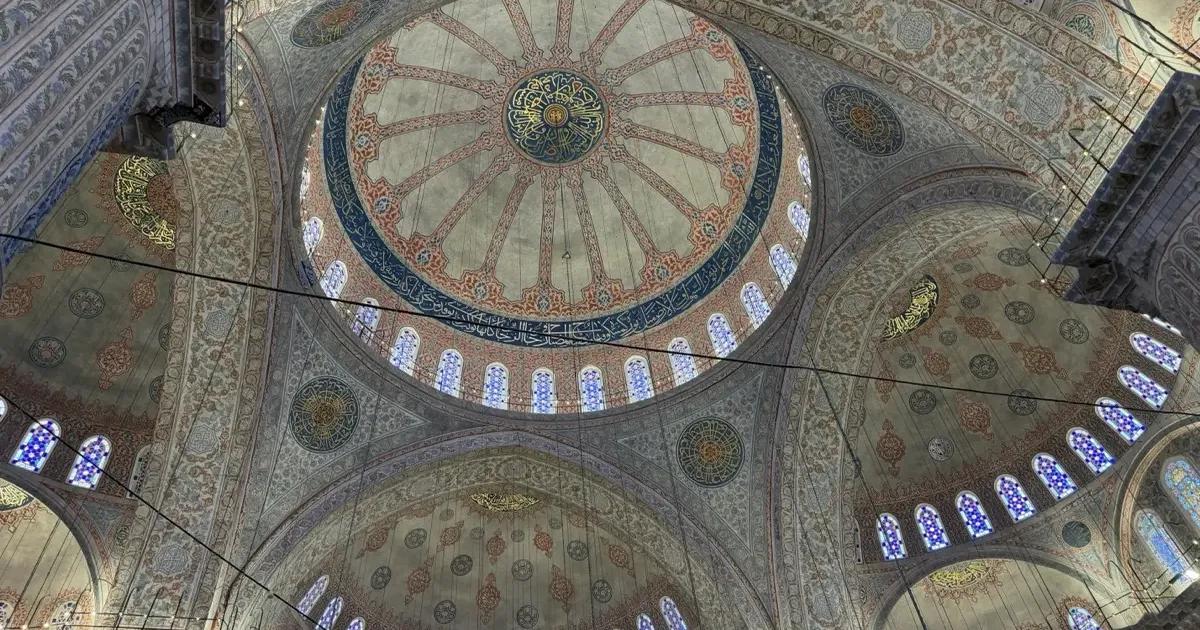 Interior view of the Blue Mosque (Sultan Ahmed Camii) in Istanbul with its iconic blue Iznik tiles and central dome