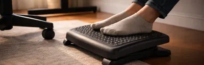 Collection of under-desk footrests in different styles on a floor