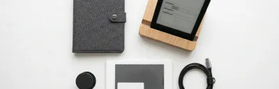 Collection of Kindle accessories including cases, stands, and chargers