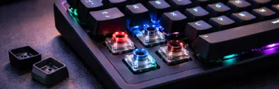 Collection of mechanical keyboards with colorful keycaps on a desk