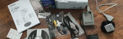 Olympus PEN E-PM2 camera on a desk in a modern workspace