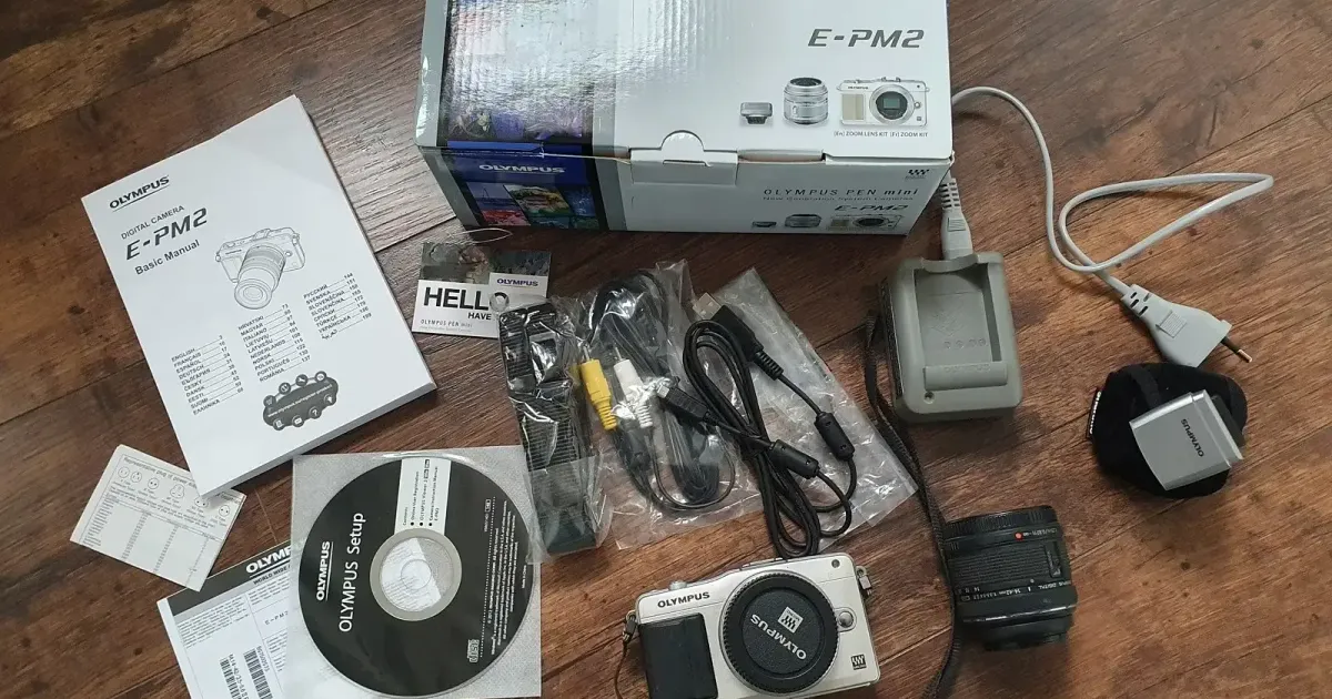 Olympus PEN E-PM2 camera on a desk in a modern workspace