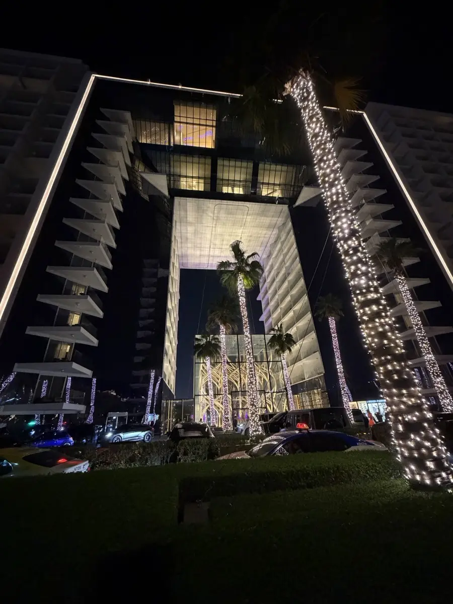 Five Palm Jumeirah entrance at night — illuminated palm trees and modern architecture on the Palm