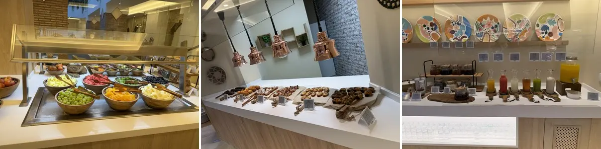 Iberostar Selection Coral Beach breakfast buffet — fresh fruit, pastries under copper lamps, and colorful juice carafes